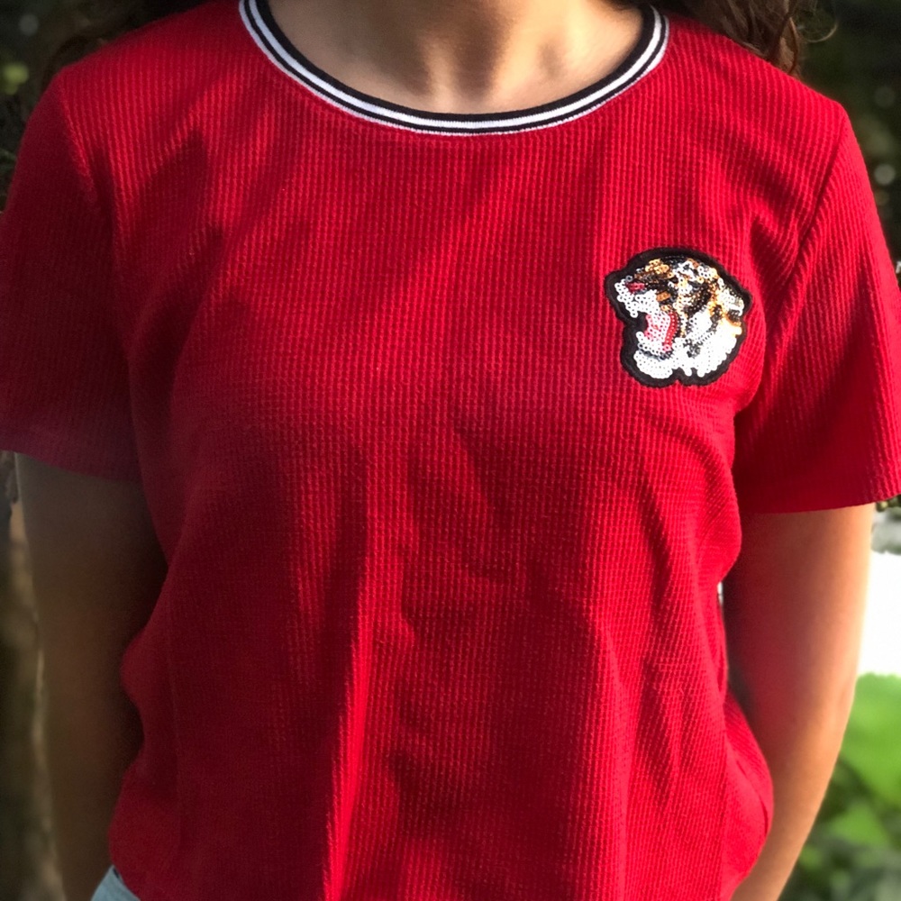 red shirt with sequin lion.